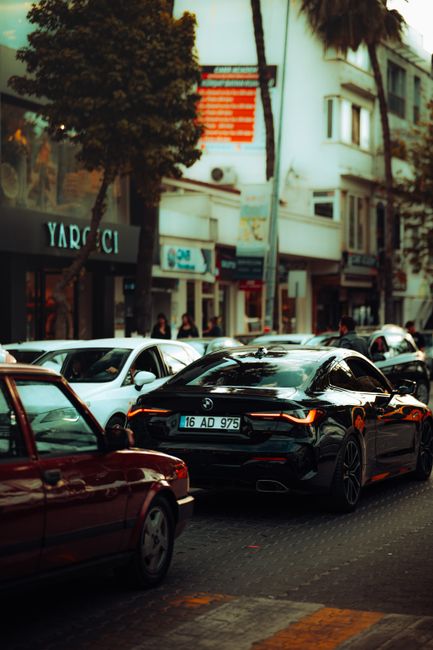 A bustling city street with modern vehicles highlighting urban life and traffic dynamics.