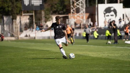 Aït-Nouri signe deux passes dans le 5-0 de City A soccer player skillfully executing a pass during a daytime match on a grassy field.