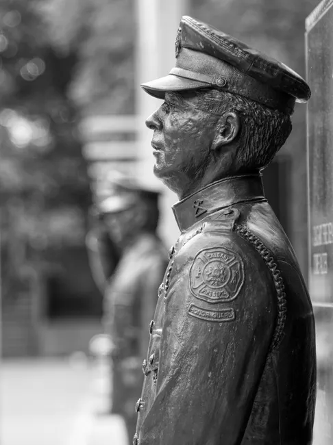 Black and white close-up of a statue of a police officer in Calgary, Canada.