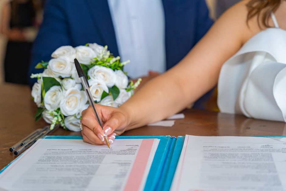 Giplait et Bellakt préparent un projet de lait infantile en Algérie Bride signs marriage certificate during elegant indoor wedding ceremony, symbolizing commitment and togetherness.