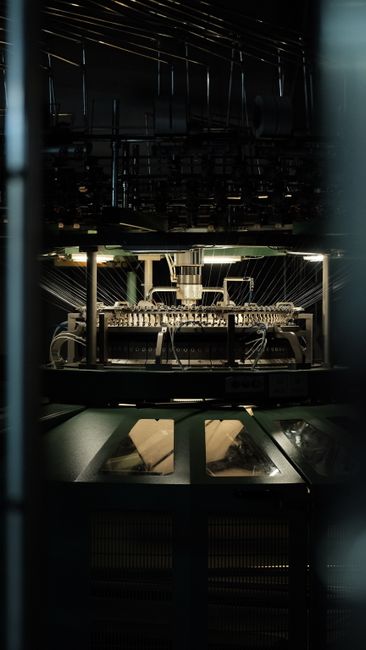 Close-up view of an industrial textile machine active in a factory.
