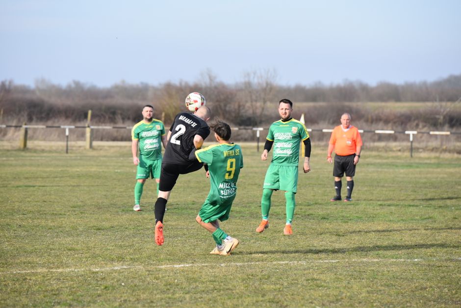 Competitive amateur football match on a clear day in Vásárosnamény, Hungary.