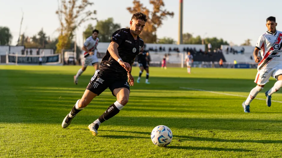 Affaire Aït-Nouri : le sélectionneur garde la main Dynamic action shot of a football match, capturing players in motion during a sunset game.