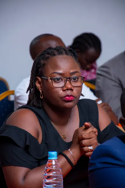 Engaged woman in a conference room attentively listening during a lecture in Bujumbura.