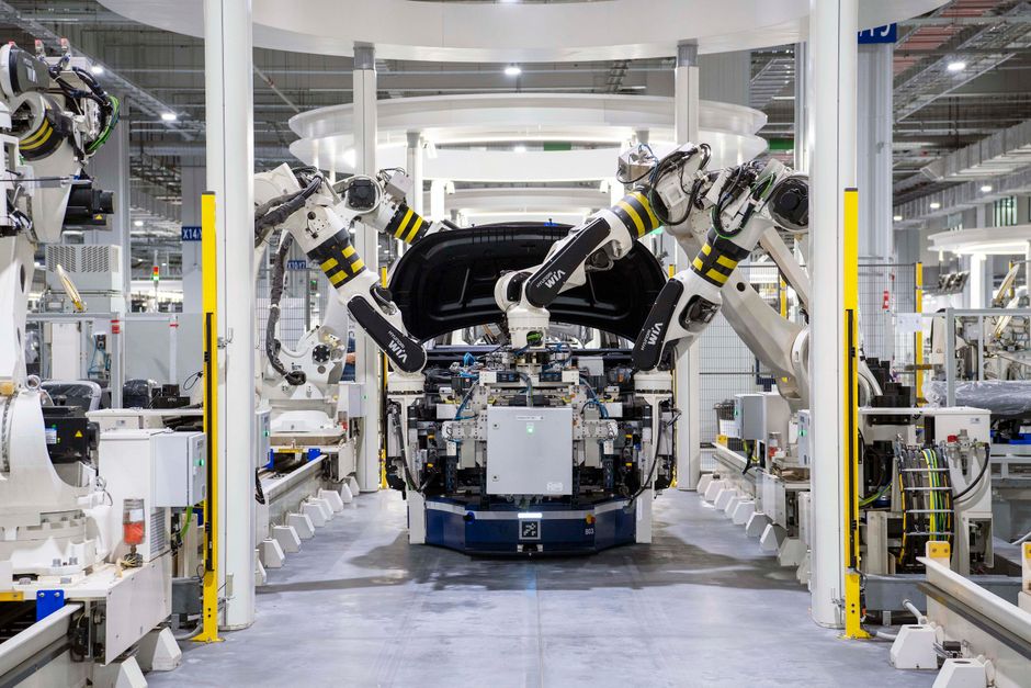 Tissemsilt : General Plastic Injection vise la chaîne automobile High-tech robots assembling a car in a modern factory setting, showcasing automation.
